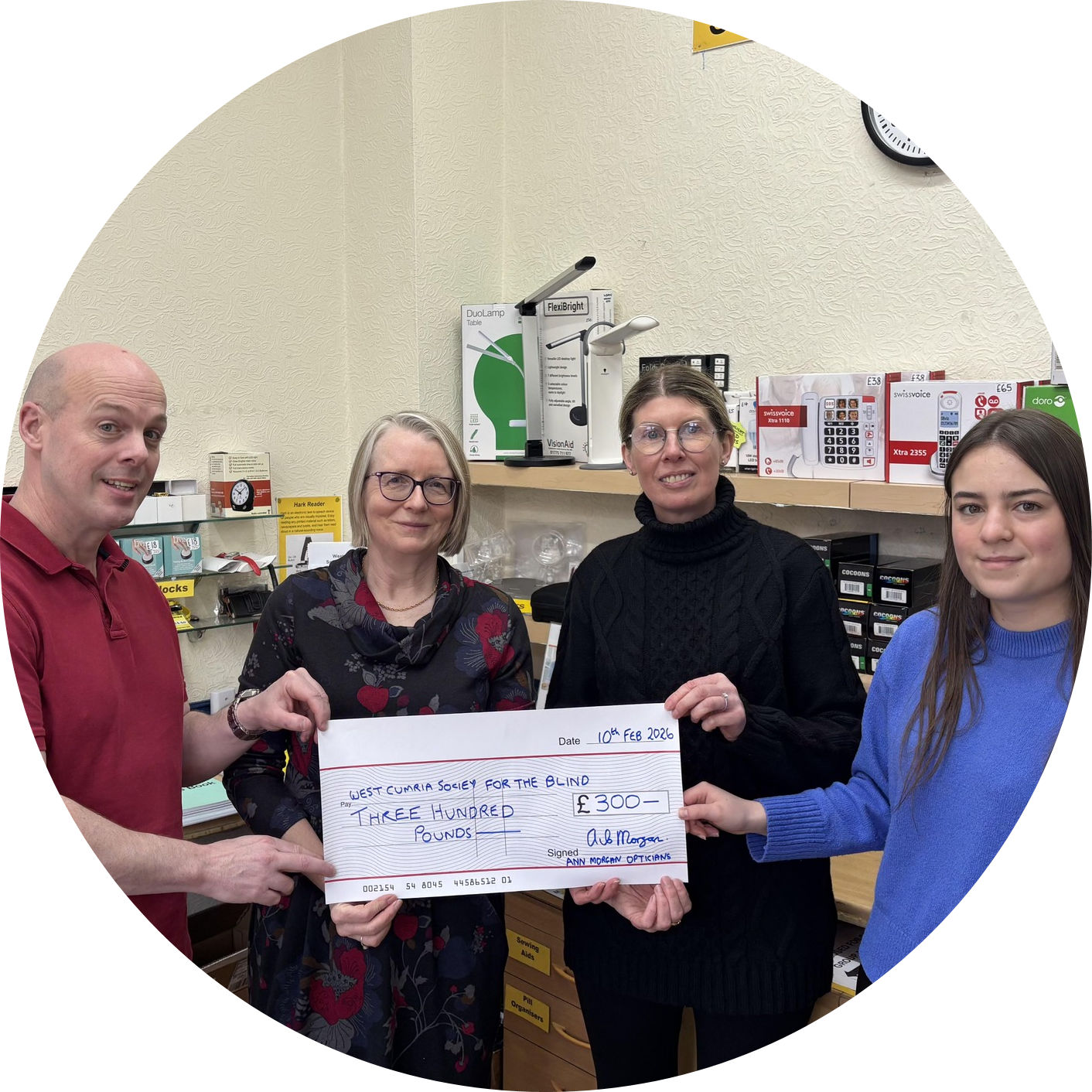 Ann Morgan Opticians presenting a cheque to members of staff from Sight Support West Cumbria 