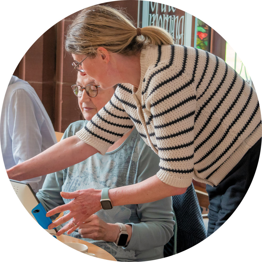  Vision Support Officer from Sight Support West Cumbria  demonstrating digital magnifier to client