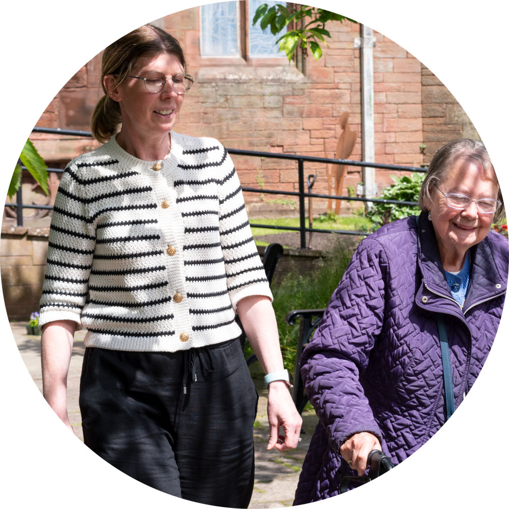Vision Support Officer walkign with a client 