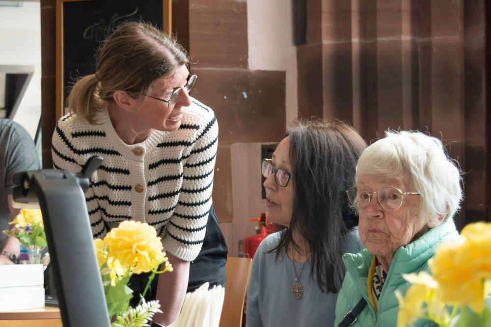  Vision Support Officer from Sight Support West Cumbria  demonstrating digital magnifier to client